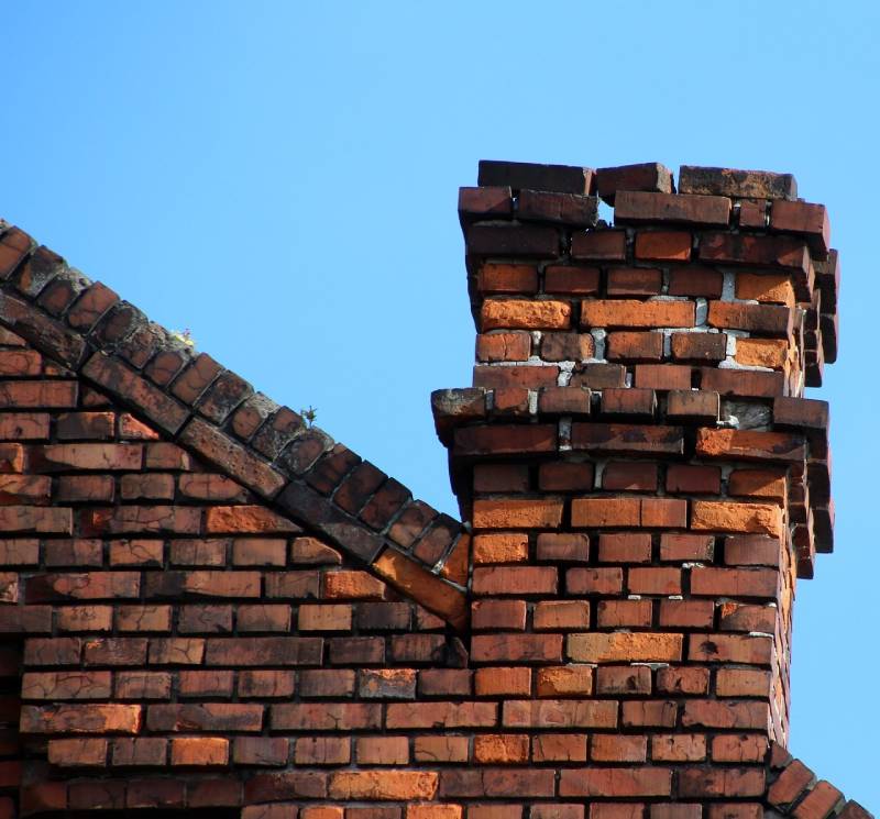 Damaged chimney on an Marshfield home showing cracks and missing mortar